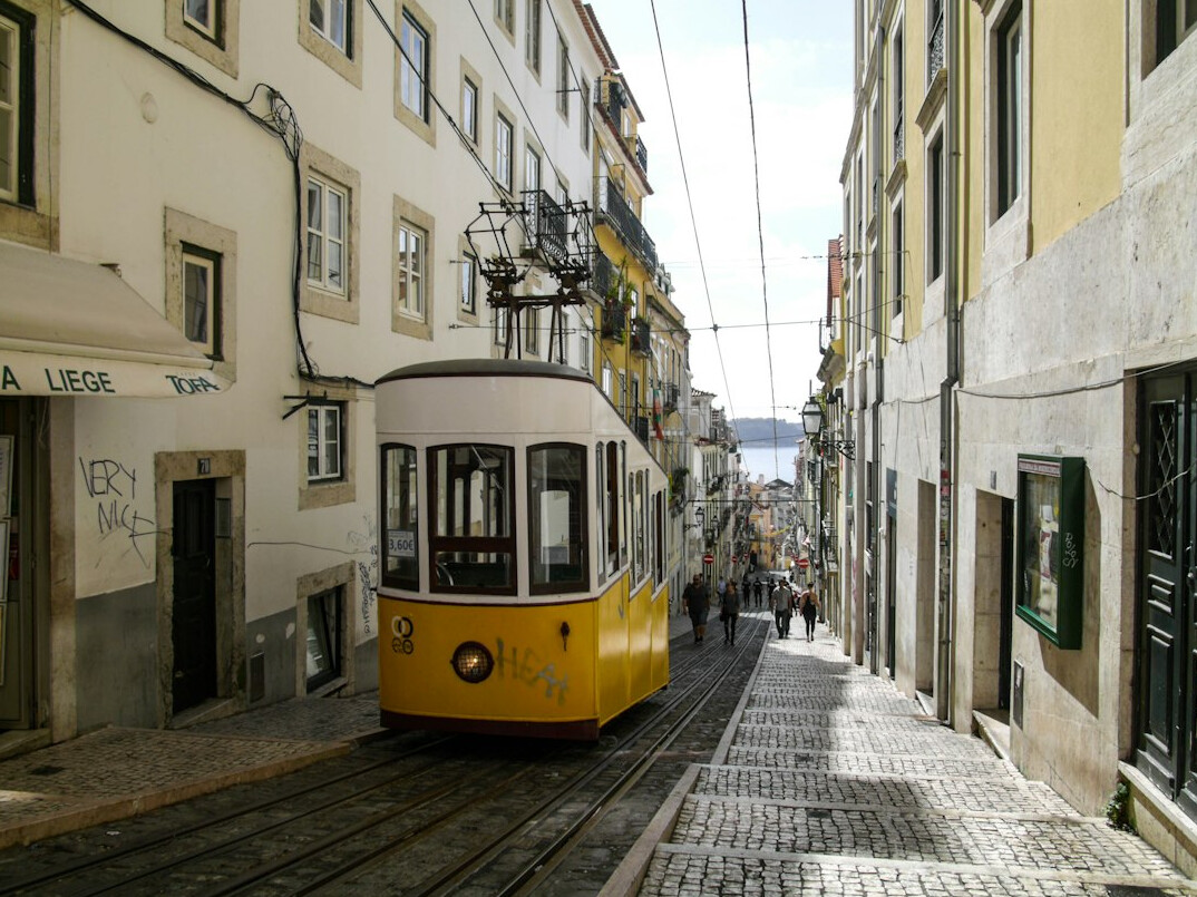 Yellow tram on a street in Lisbon