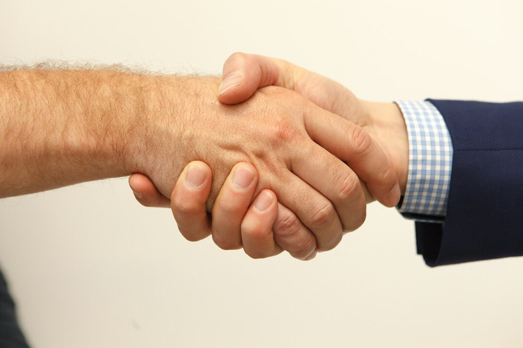 powerful businessmen handshake